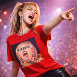 Person wearing a red t-shirt with a graphic design, pointing forward against a colorful background.