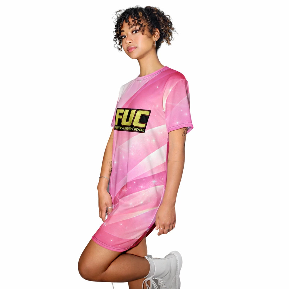 Person wearing a pink dress with a yellow 'FUC' logo on a white background