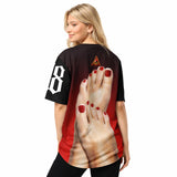 Person wearing a black and red t-shirt with a graphic of a foot on the back.